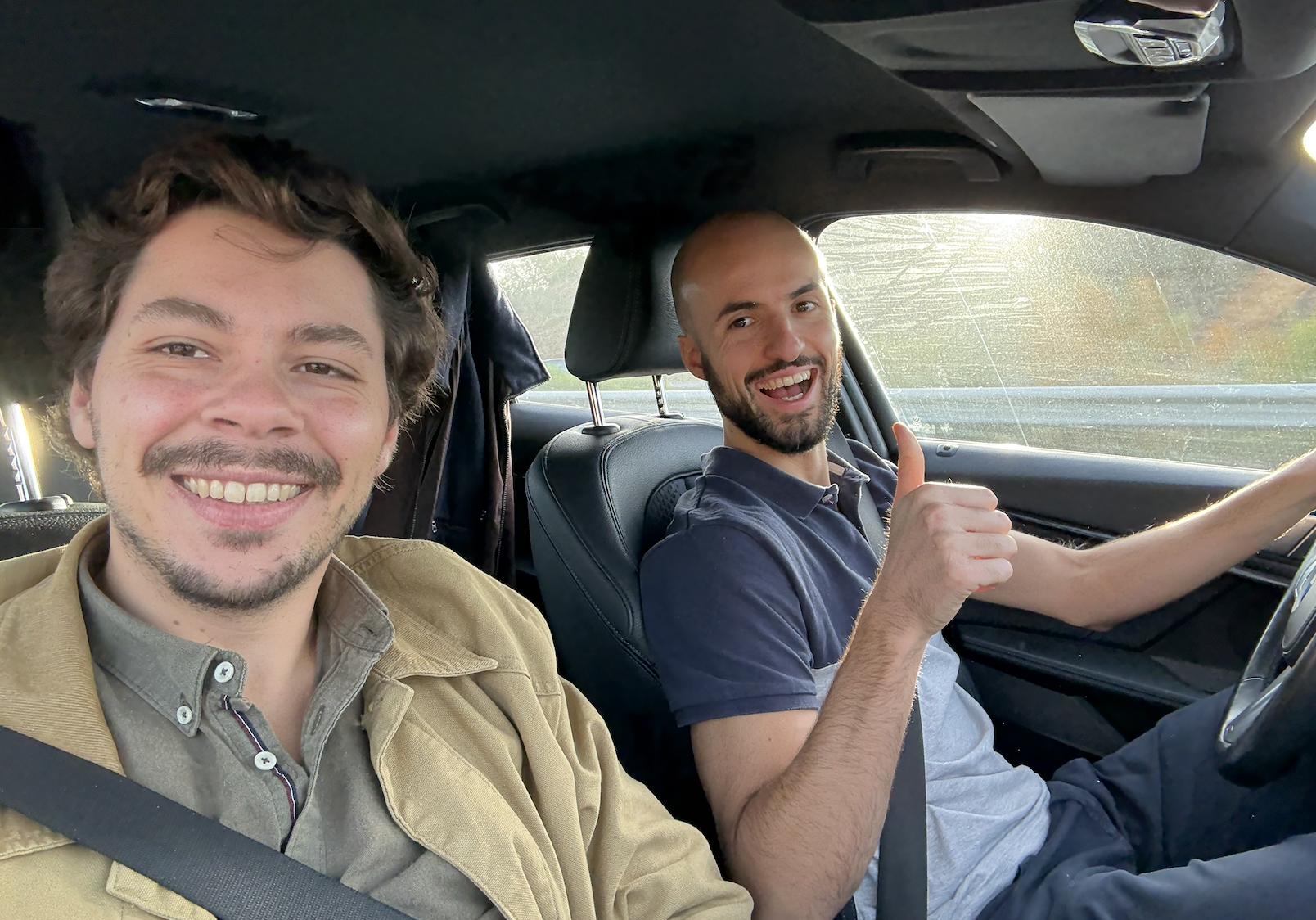 Two people in car, joyful candid moment driving through Portuguese countryside